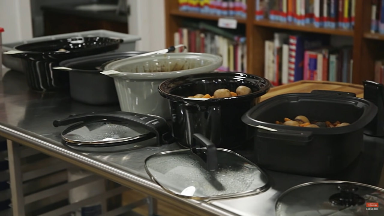 five crockpots on the table and lids near it