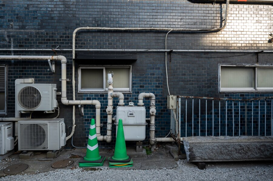 Geothermal heat pump outdoors with green road cone